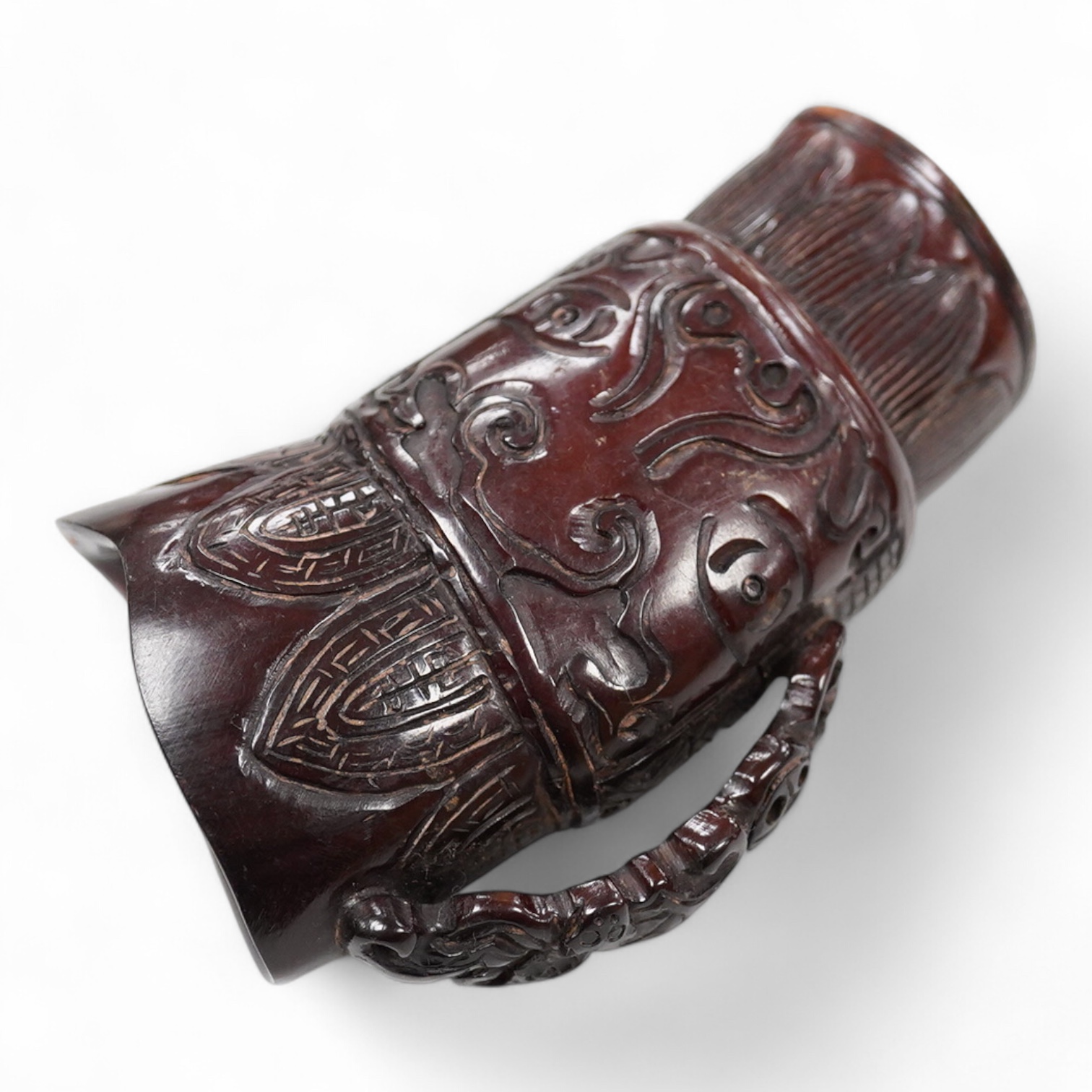 A Chinese carved horn jug, 11cm high